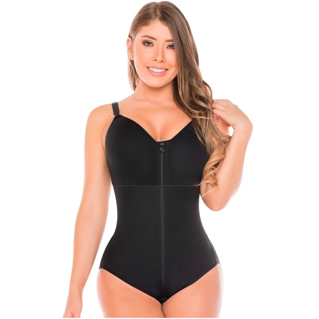 Woman modelling a black full-body compression bodysuit with adjustable straps and front zip closure.