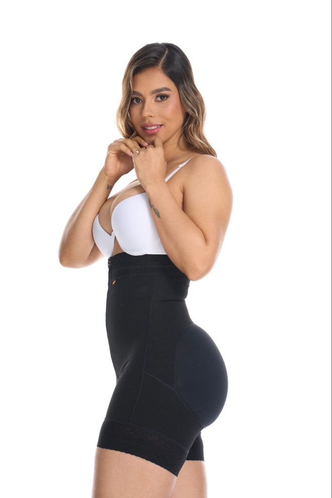 Woman modelling black high-waisted BBL compression shorts from the side.